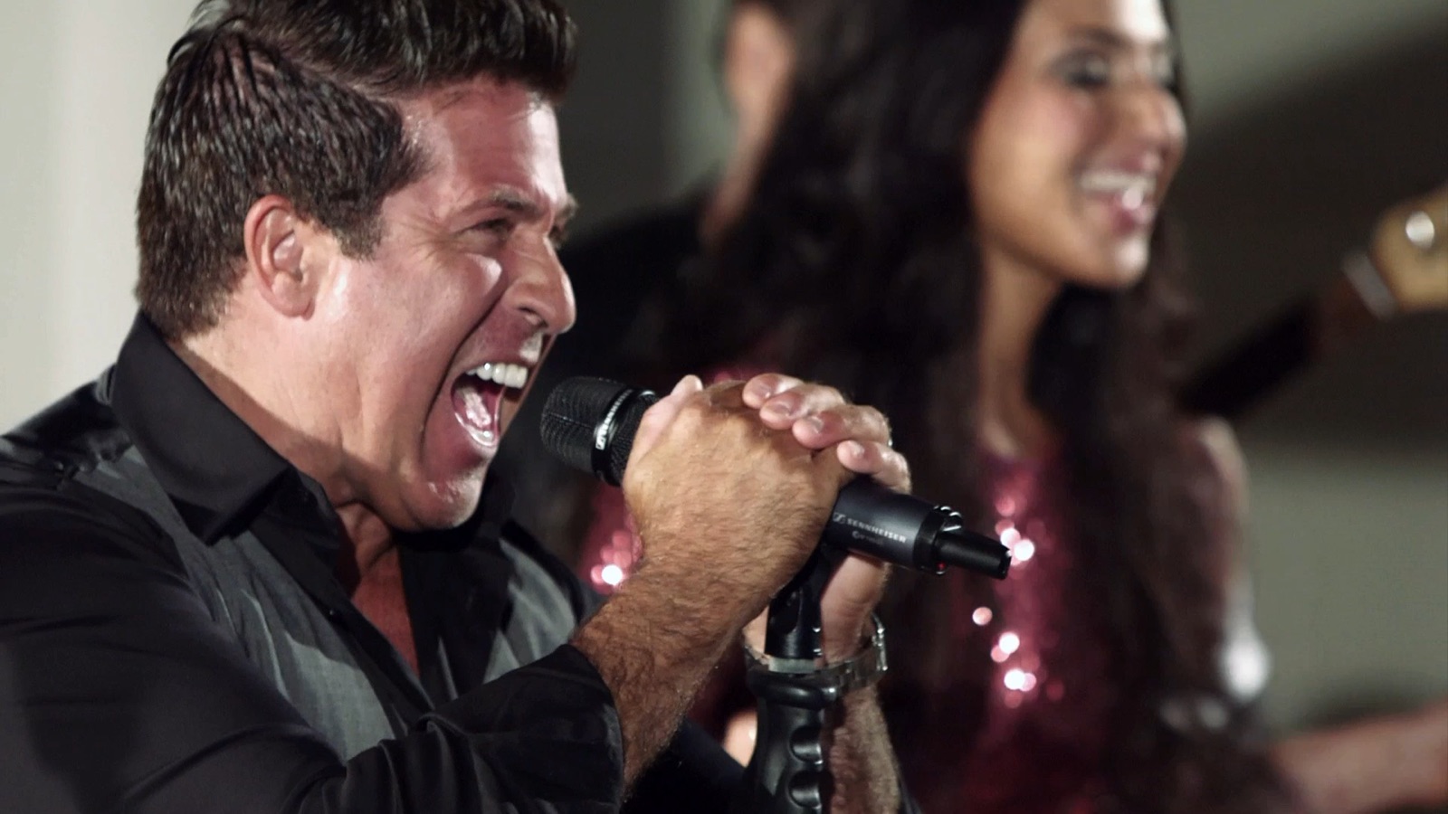 Steve DeLisi singing with intensity, close-up